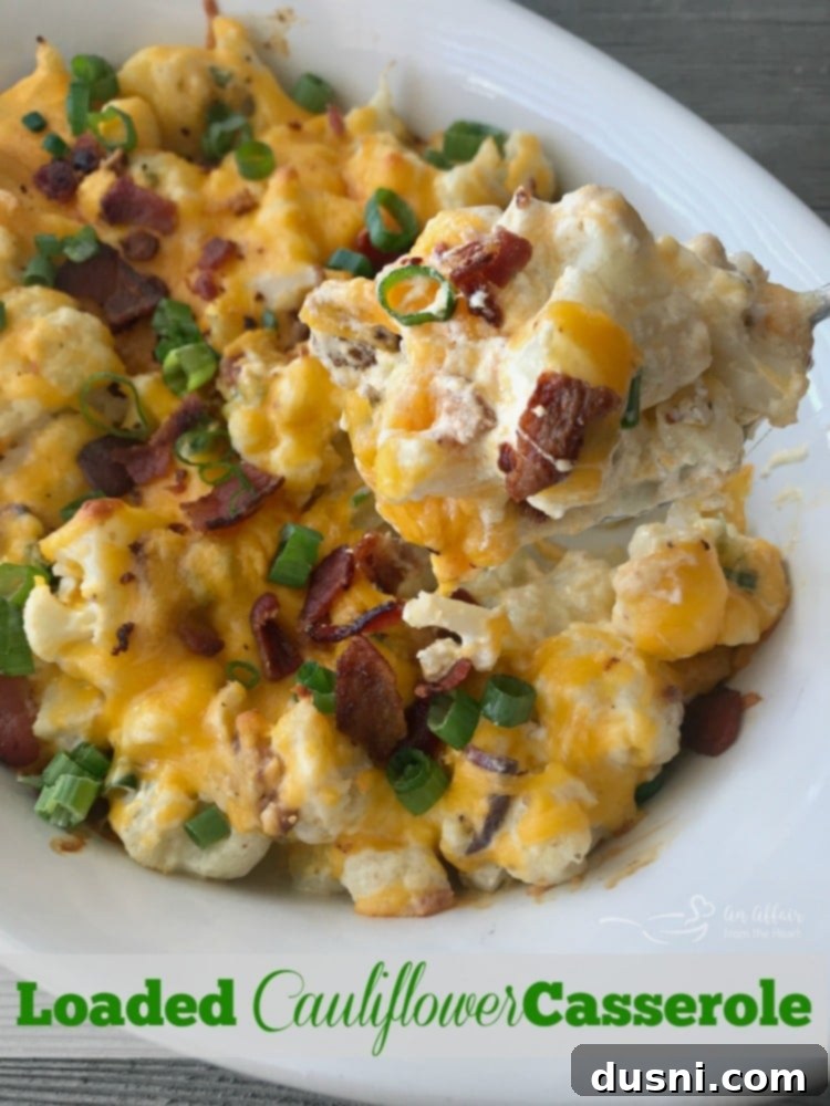 A serving of Loaded Cauliflower Casserole on a plate with fresh scallions.