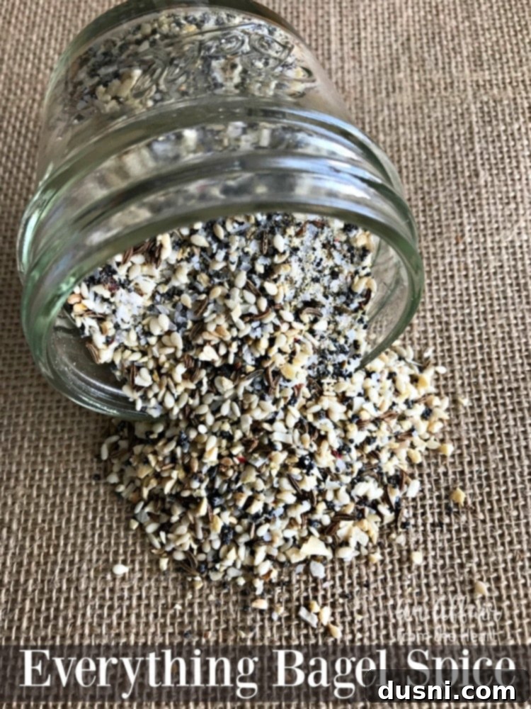 A top-down view of Everything Bagel Spice in a jar, ready for use.