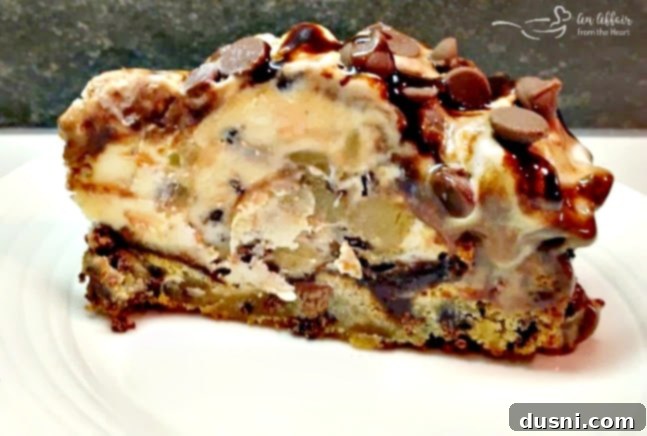 Ultimate Chocolate Chip Cookie Dough Ice Cream Cake 7 Slice of Chocolate Chip Cookie Dough Ice Cream Cake with a full cookie bottom visible.