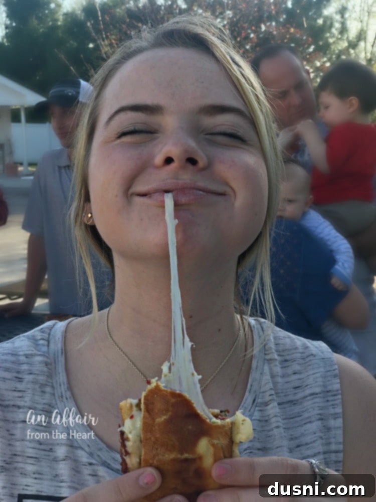Fiery Chili Cheese Dog Melt 12 Extreme close-up of a Spicy Grilled Cheese Chili Dog with an impressive cheese pull