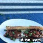 Fiery Chili Cheese Dog Melt 15 Spicy Grilled Cheese Chili Dog on a white plate with a side of chili