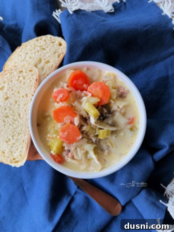 Creamy Sauerkraut, Bratwurst, and Potato Soup in a rustic bowl
