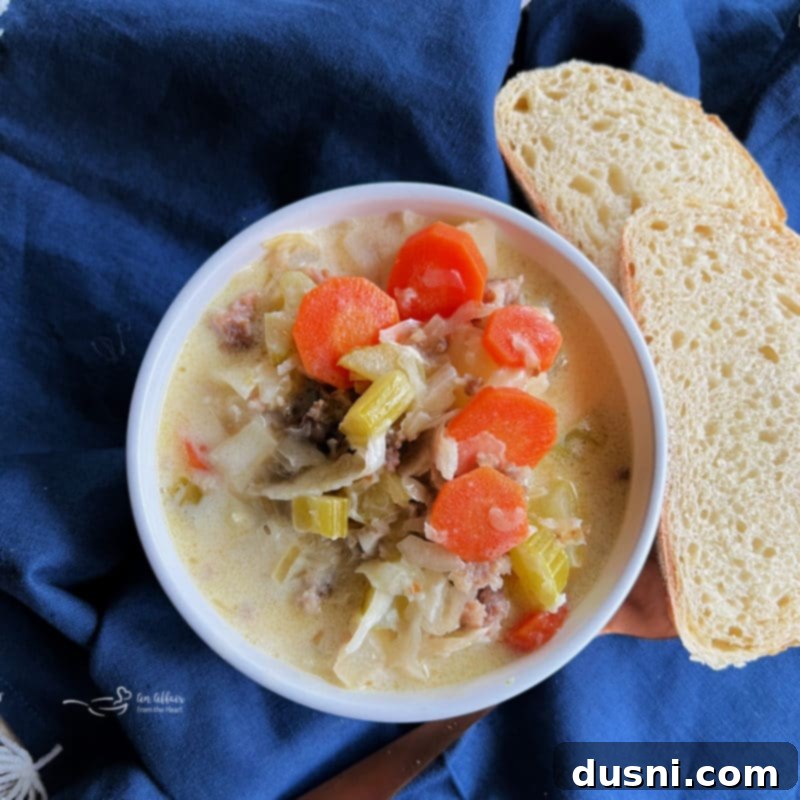 creamy bowl of sauerkraut soup with spoon