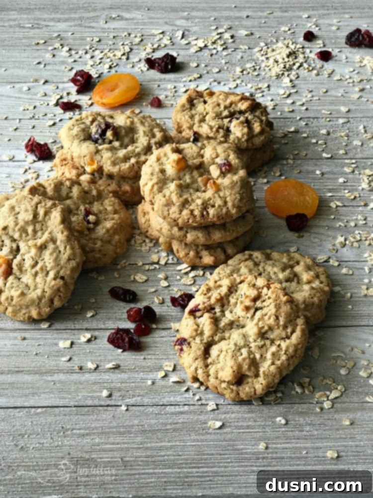 Delicious Cranberry Apricot Oatmeal Cookies stacked on a cooling rack, showcasing their chewy texture and fruit inclusions.