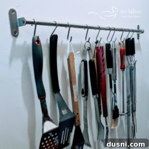 Pantry wall with S-hooks holding various kitchen utensils
