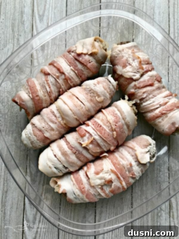 Kraut Stuffed Bacon Wrapped Brats for tailgate - ready to be grilled