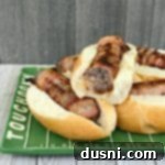 Kraut Stuffed Bacon Wrapped Brats on a festive plate for tailgating