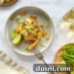 Doritos Taco Casserole on a plate with lime wedges.