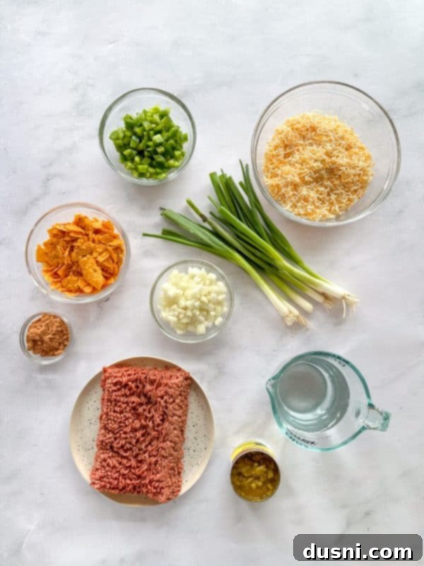 A whole Doritos Taco Casserole in a glass baking dish, fresh from the oven, with golden bubbly cheese and a crunchy top layer.