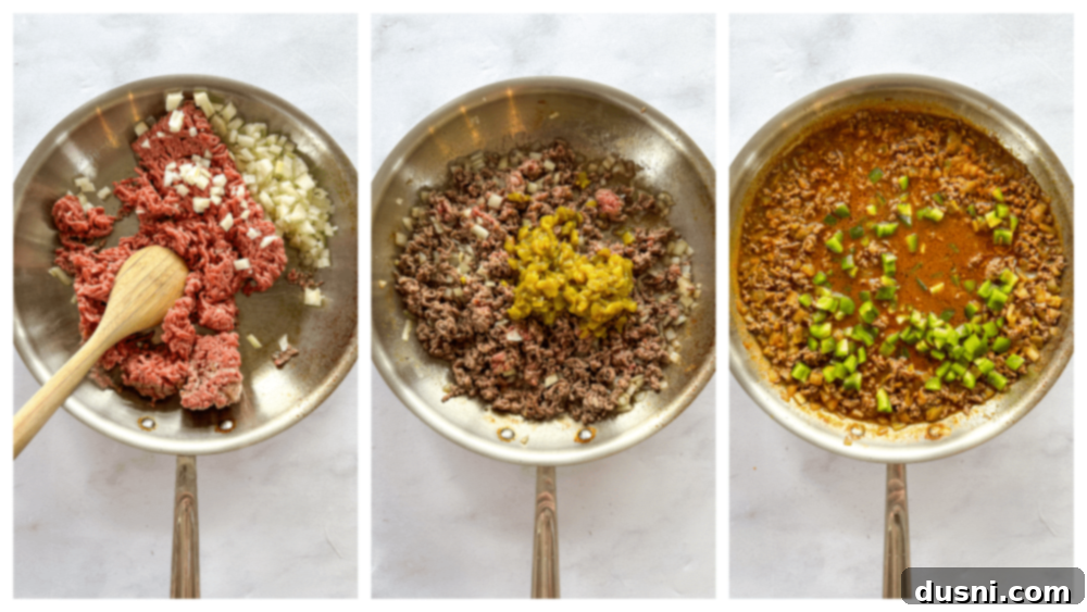 A large skillet containing browned ground beef and chopped onions, ready for the next steps of the taco casserole recipe, with a wooden spoon mixing the ingredients.