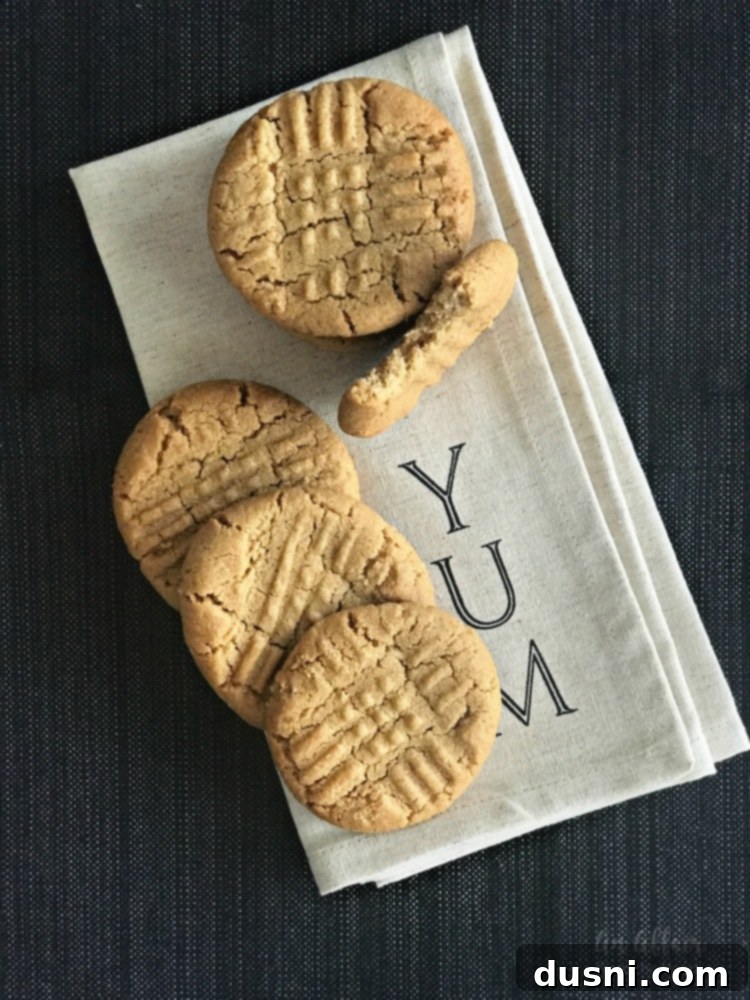 Easy 3-Ingredient Peanut Butter Cookies 6 A batch of delicious 3-ingredient peanut butter cookies cooling on a wire rack.