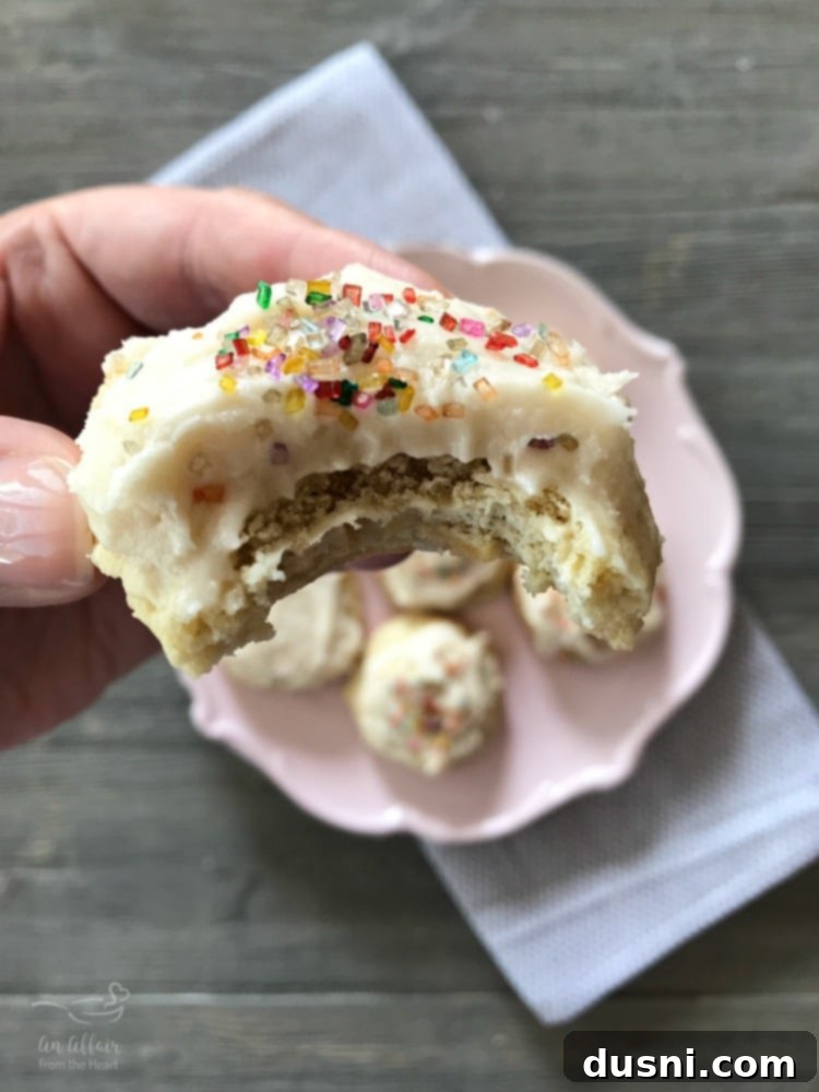 Homestyle Frosted Sour Cream Sugar Cookies 5 Old Fashioned Frosted Sour Cream Sugar Cookies with a bite taken out