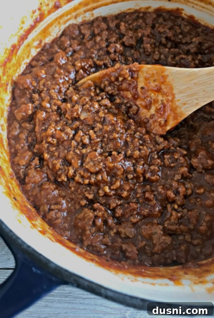 Sloppy Dorothy meat simmering in a Dutch oven on the stovetop