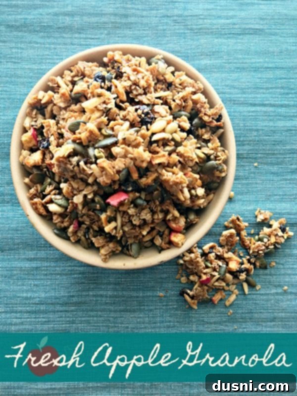 A bowl of freshly baked Fresh Apple Cinnamon Granola with dried cherries and almonds