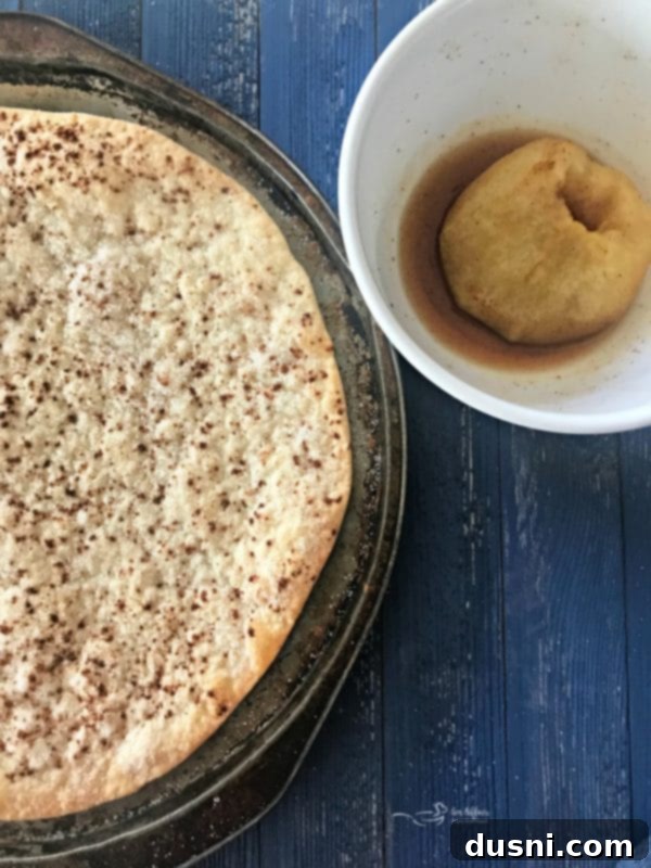 Homemade Dairy Queen Apple Pie Blizzard 9 Refrigerated pie crust sprinkled with cinnamon and sugar on a pizza pan, ready for baking to a crisp.