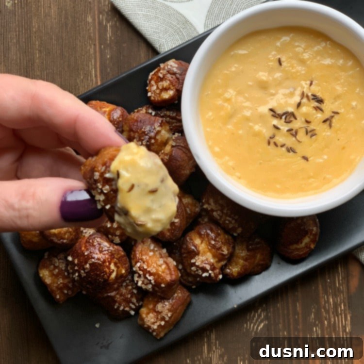 Cheesy Sauerkraut Pretzel Poppers 15 Quick Pretzel Bites with Sauerkraut Cheddar Cheese Sauce dip, garnished with caraway seeds