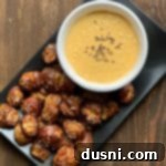 Cheesy Sauerkraut Pretzel Poppers 19 Overhead shot of Quick Pretzel Bites with Sauerkraut Cheddar Cheese Sauce dip plated beautifully