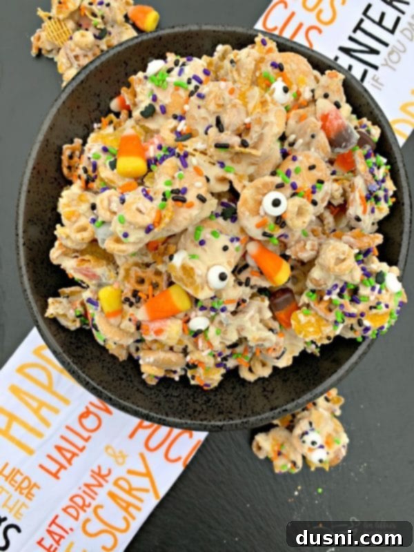 Monster Mash Snack Mix 2 Delicious Halloween White Trash Snack Mix with colorful candy corn and candy eyes