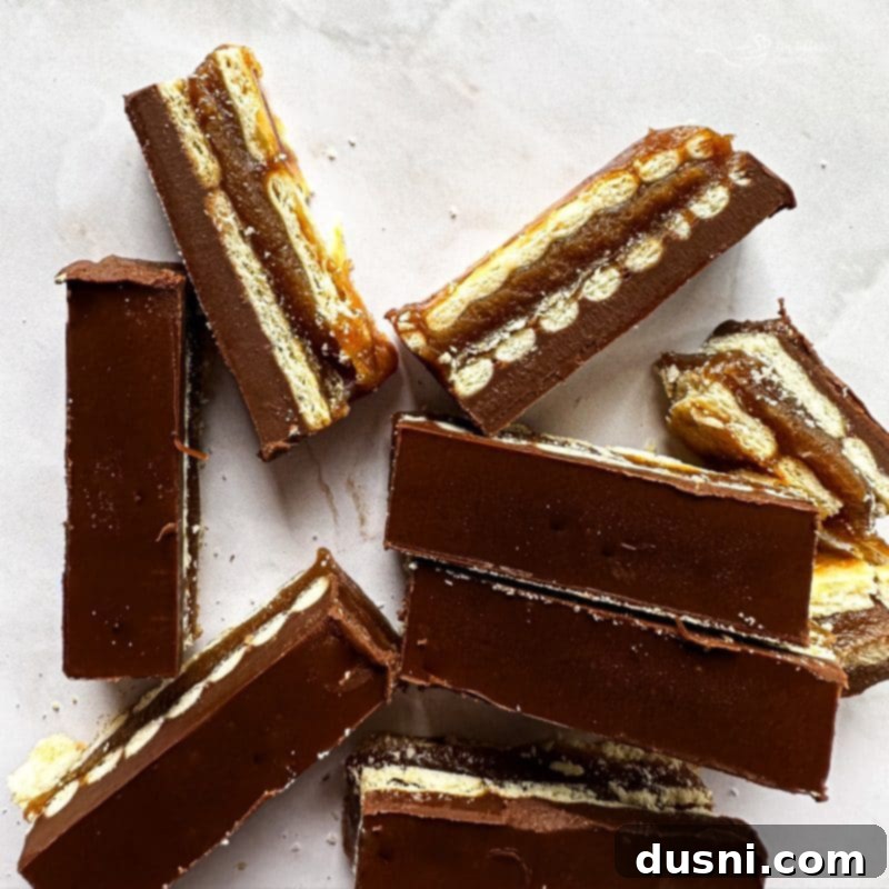 Homemade Caramel Shortbread Chocolate Bars 14 Many Homemade Twix Bars stacked on a white plate