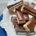 Homemade Caramel Shortbread Chocolate Bars 20 Homemade Twix Bars stacked on a white serving plate