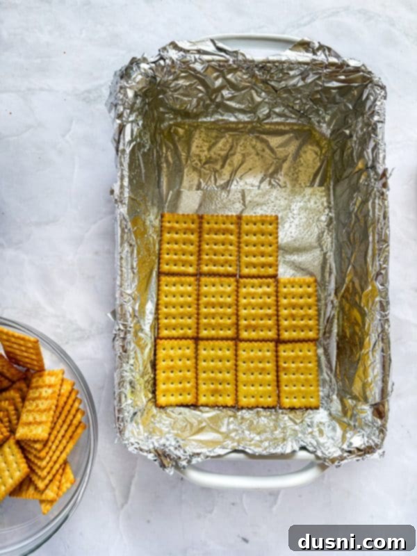 Homemade Caramel Shortbread Chocolate Bars 5 Lining a baking dish with foil and spraying