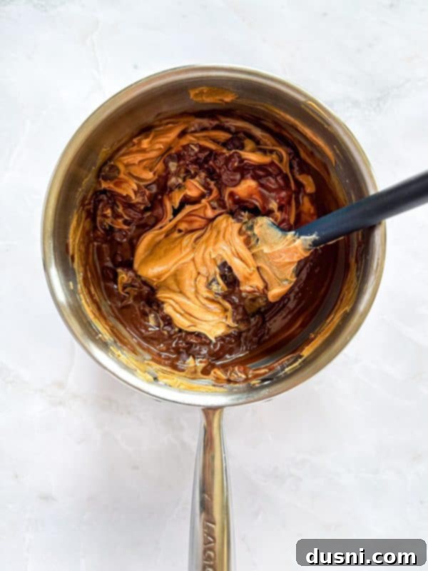 Homemade Caramel Shortbread Chocolate Bars 8 Pouring caramel over crackers and adding another cracker layer