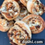 Close up of Steak & Kraut Pinwheels with Caramelized Onions and White Cheddar Cheese