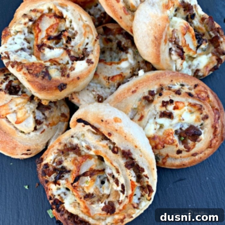 Overhead view of freshly baked Steak & Kraut Pinwheels, highlighting the golden crust and generous filling of steak, kraut, onions, and cheese