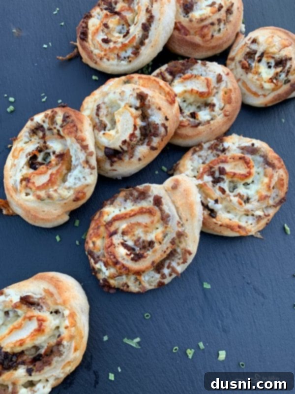 A close-up of a tray of freshly baked Steak & Kraut Pinwheels, ready to serve