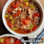 Two bowls of hearty Stuffed Pepper Soup with rice and ground beef, garnished with fresh parsley.