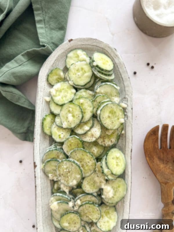 Freshly made Cucumber Ranch Salad in a white bowl, garnished with dill.