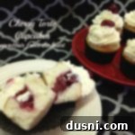 Cherry torte cupcake cut in half on a white plate and others on a red plate and text "cherry torte cupcakes"