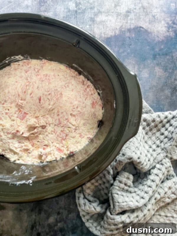 Spreading Reuben Dip into a slow cooker