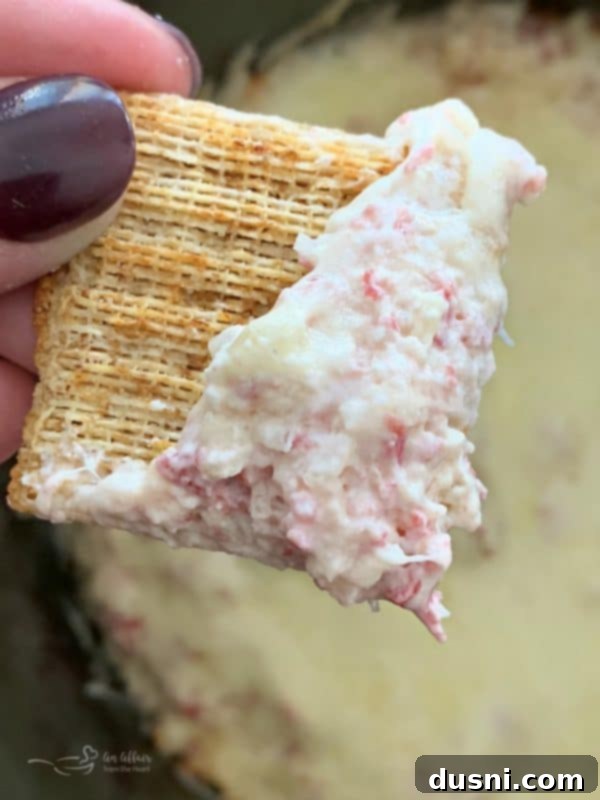 Close-up of Crock Pot Reuben Dip on a cracker