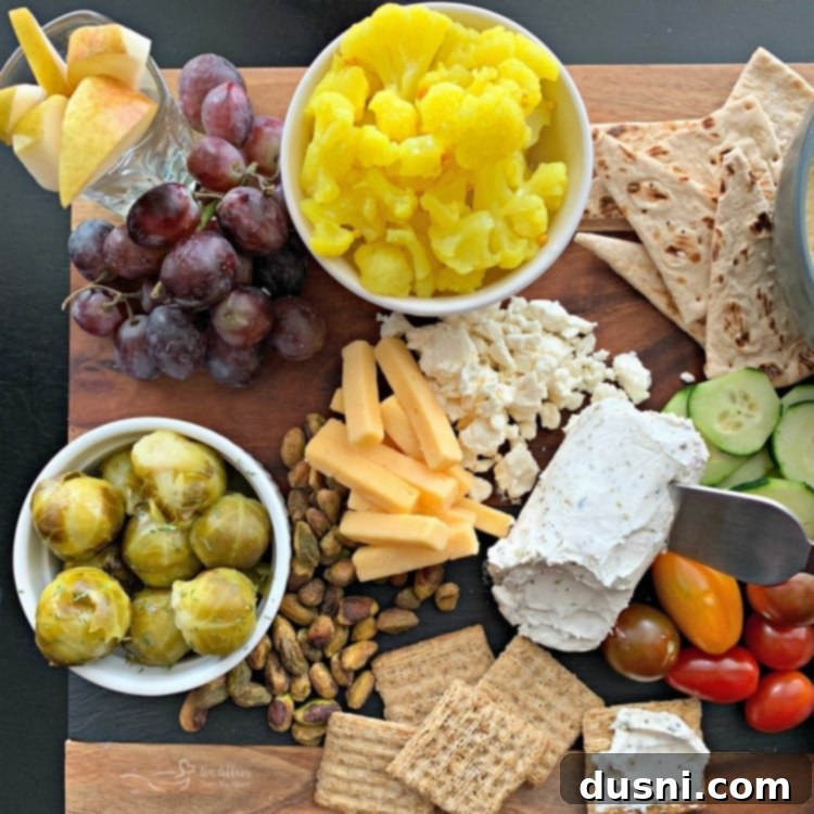Sun-Kissed Mezze Platter with Creamy Cauliflower Hummus 2 Lush Mediterranean Inspired Cheeseboard with vibrant Cauliflower Hummus