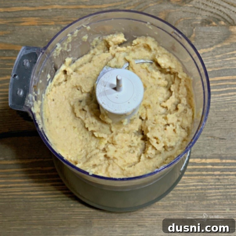 Sun-Kissed Mezze Platter with Creamy Cauliflower Hummus 8 Mixing ingredients for Cauliflower Hummus in a food processor