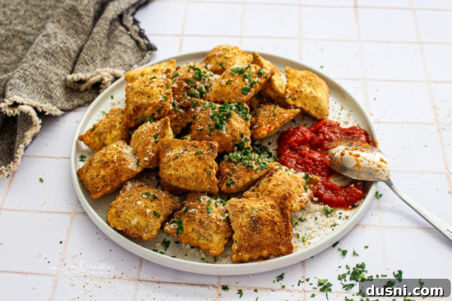 Air Fryer Toasted Ravioli served with marinara sauce.