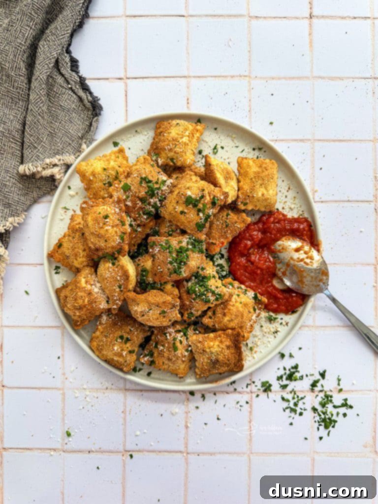 Close-up of golden brown air fried toasted ravioli.