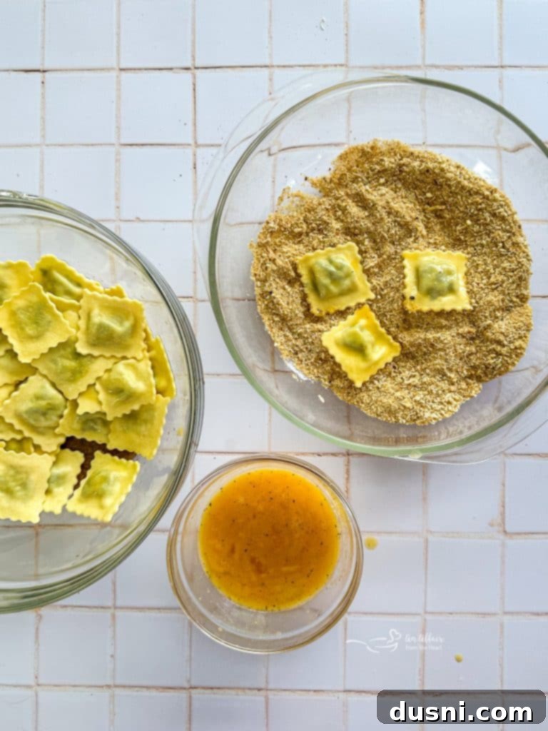 Breading ingredients in separate bowls.