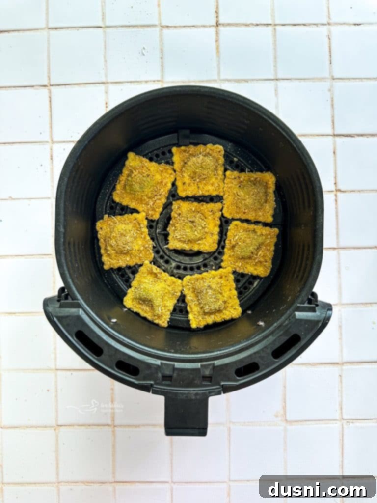 Dipping ravioli into breadcrumbs.