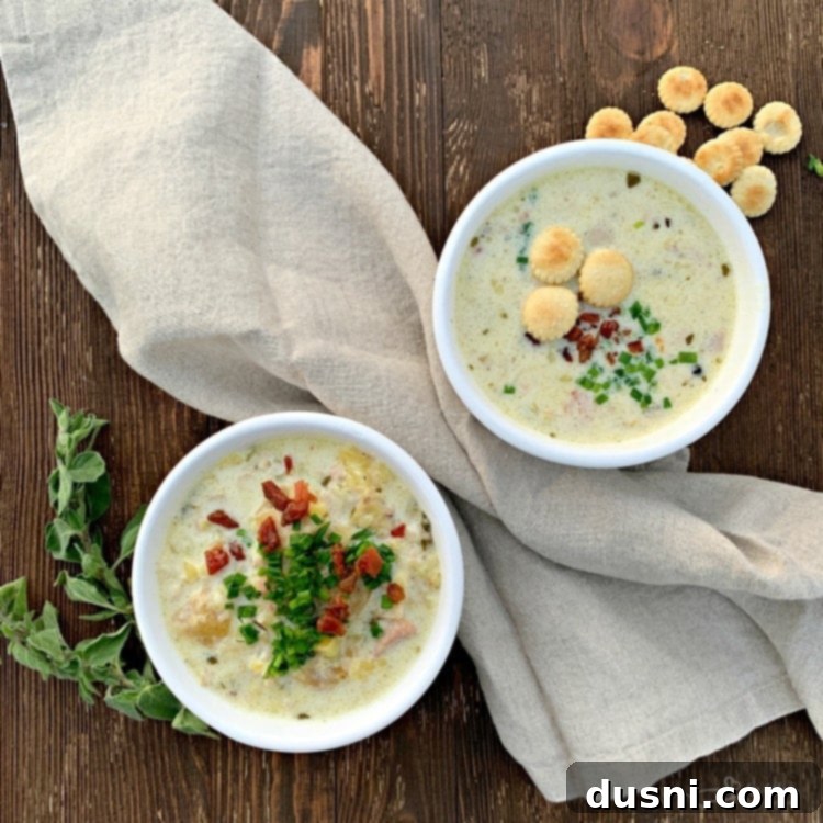 Delicious and creamy Instant Pot New England Clam Chowder in a bowl, garnished with fresh herbs and oyster crackers
