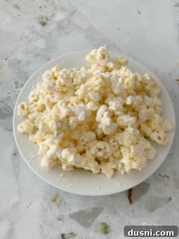 Enchanted Winter Mix 3 Close-up of freshly coated Winter Wonderland Popcorn, sparkling with sugar