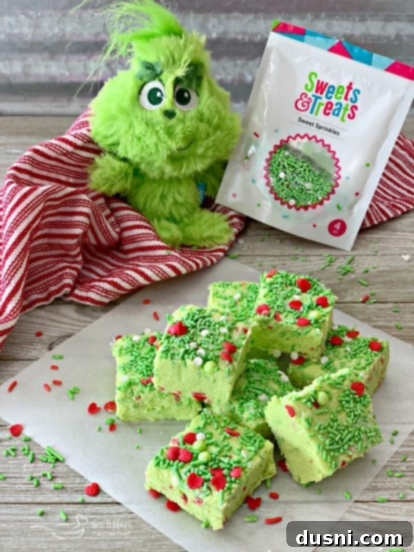Grinch Fudge squares topped with an abundance of 'Mean One' sprinkles, ready for the holidays.