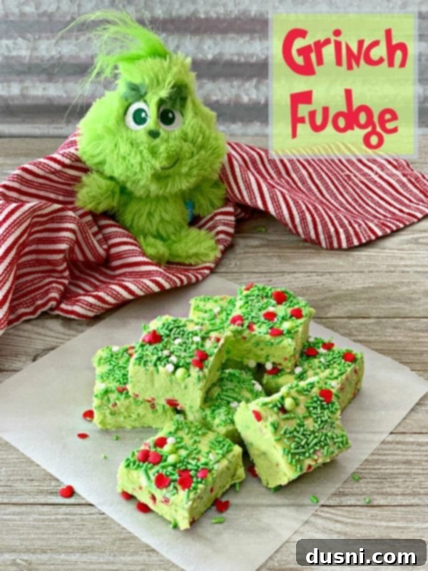 Grinch Fudge squares artfully arranged with a small Grinch dog toy in the background, creating a festive scene.