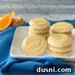 Velvet Orange Dream Cookies 11 Orange Meltaway Cookies stacked on a white plate