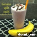 Banana split malt in a large glass with a straw with a banana next to it and text 'banana split malt