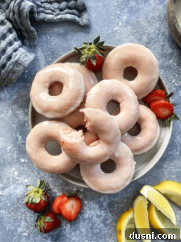 Decadent Baked Chocolate Covered Strawberry Donuts 18 Baked strawberry lemonade donuts, stacked on a white plate