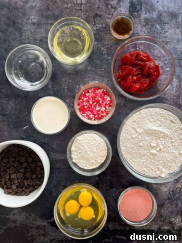 Decadent Baked Chocolate Covered Strawberry Donuts 6 A close-up of two chocolate covered strawberry donuts with sprinkles