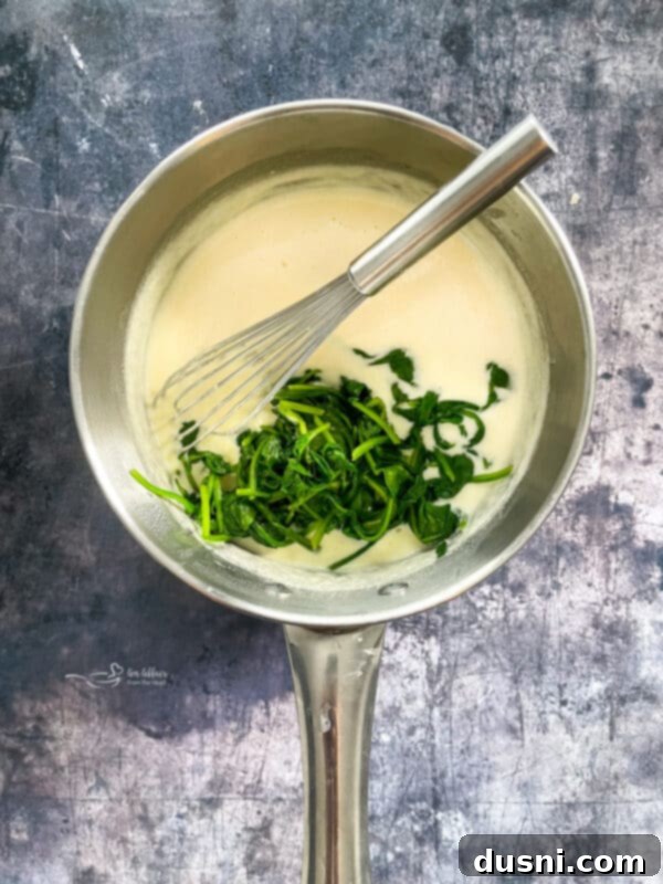 Add the wilted spinach to the sauce.