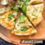 cutting and serving spinach and alfredo pizza